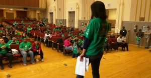 Comcast Cares Day coordinator Kristina Chang (254) instructs volunteers in Central's auditorium Saturday April 30 as they prepared to tackle beautification projects around the school.