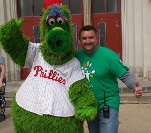 Central President Tim McKenna takes a break on Comcast Cares Day for fun with the Phillie Phanatic.