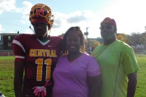 Wide receiver Collin Washington is joined by his parents on the field at halftime.